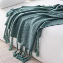 A soft and breathable knitted fringed blanket