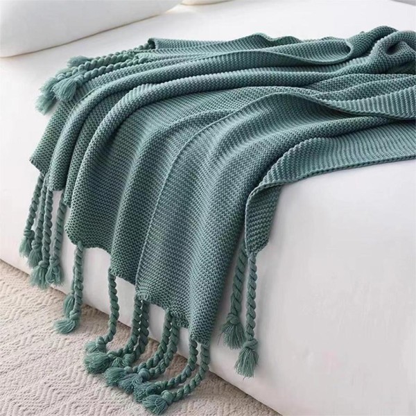 A soft and breathable knitted fringed blanket