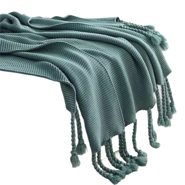 A soft and breathable knitted fringed blanket